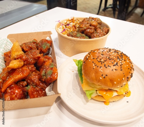 Korean deep dried spicy red chicken sauce in a paper takeaway box.