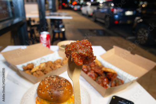 Korean deep dried spicy red chicken sauce in a paper takeaway box.