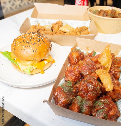 Korean deep dried spicy red chicken sauce in a paper takeaway box.