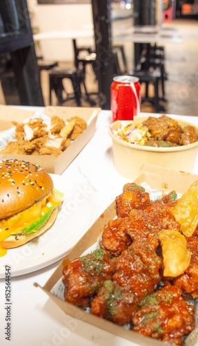 Korean deep dried spicy red chicken sauce in a paper takeaway box.