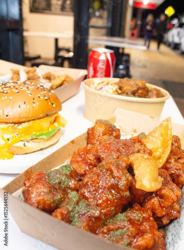 Korean deep dried spicy red chicken sauce in a paper takeaway box.