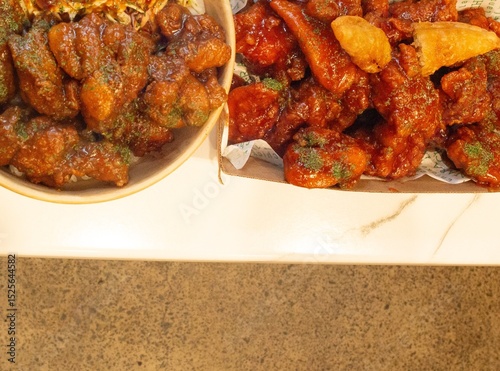 Korean deep dried spicy red chicken sauce in a paper takeaway box.