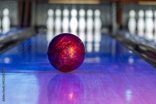 A bowling ball with bowling pins in the background