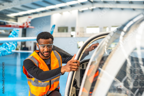 Tapeta Aircraft maintenance engineer inspecting small plane in hangar