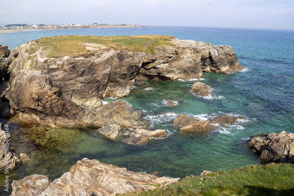 Fototapeta premium Beautiful cliffs of Playa de las Catedrales viewed from a wooden boardwalk in Ribadeo, Galicia. Nature and coastal beauty combined.