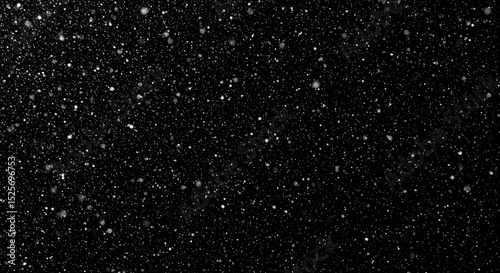 A black and white image of falling snow during a night, winter concept