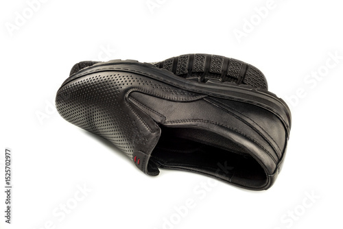 Close-up of elegant black men's shoes on a snow-white background. The photo shows a detailed view of fashionable men's shoes.