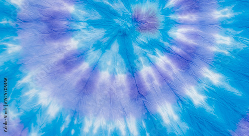 Abstract blue and purple tie-dye spiral pattern textile texture background design