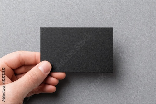 Hand holding blank black card