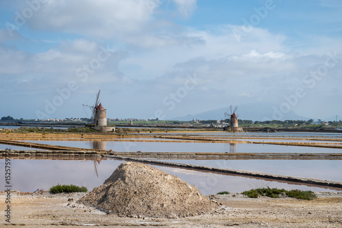 Sea saltworks, salt wind mills and pans, manually extracting high-quality salt, near Marsala and Trapani, Sicily, Italy