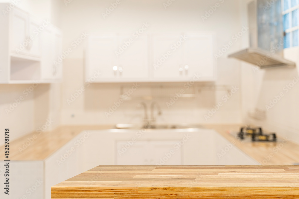 Fototapeta premium Empty wooden countertop table in modern white kitchen interior background with copy space for product display