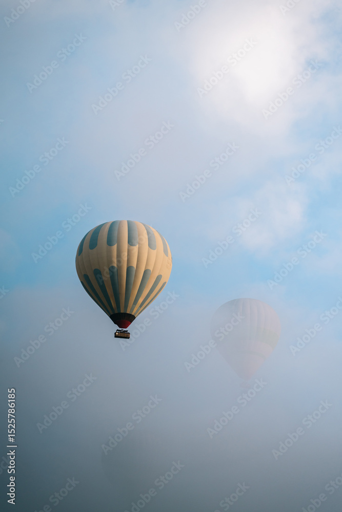 Naklejka premium Hot Air Balloons Flying Over Cloudy Cappadocia, Turkey