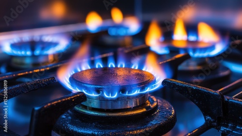 A gas stove with four lit burners, one of which is emitting a blue flame.