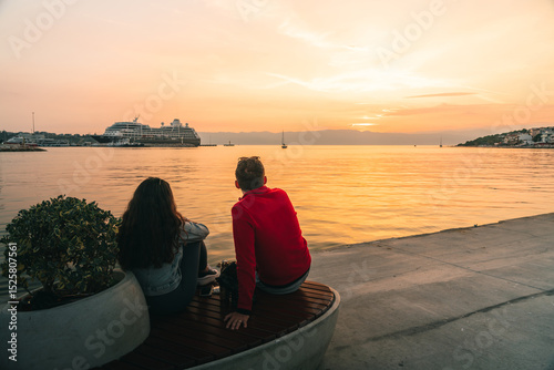 Fototapeta Naklejka Na Ścianę i Meble -  Person Watching Sunset by the Sea in Cesme, Turkey