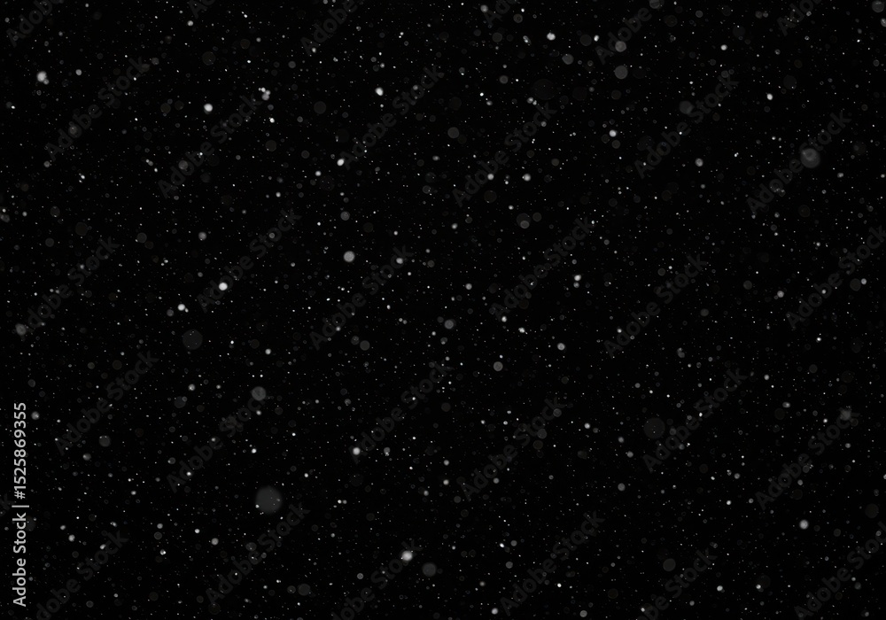 Fototapeta premium Falling snow creating a wintery and atmospheric effect on black background