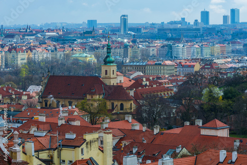  Scenic view of the old district of the Czech capital Prague with many red roofs, churches and towers