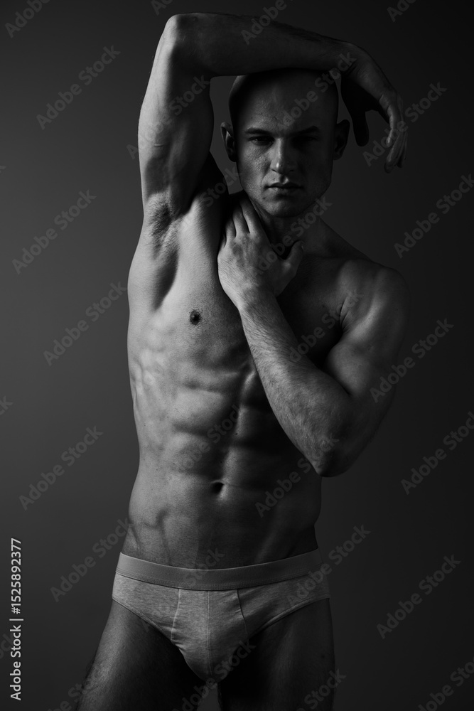 Striking black and white portrait of a muscular man showcasing strength and confidence, perfect for fitness and wellness themes, capturing intense emotion effectively. Striking black and white portrait of a muscular man showcasing strength and confidence, perfect for fitness and wellness themes, capturing intense emotion effectively.