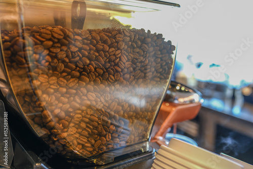 Fresh organic raw coffee beans in a coffee machine