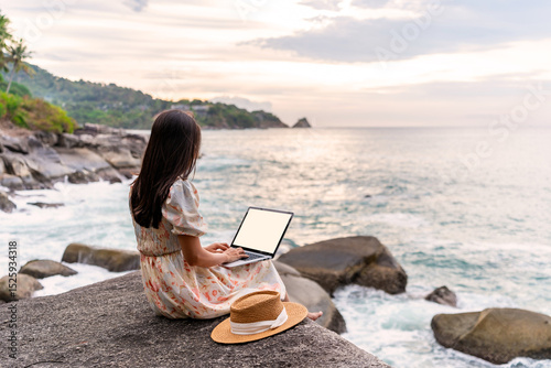 Young woman freelancer traveler working online using laptop while traveling on summer vacation, Freelance and workation concept