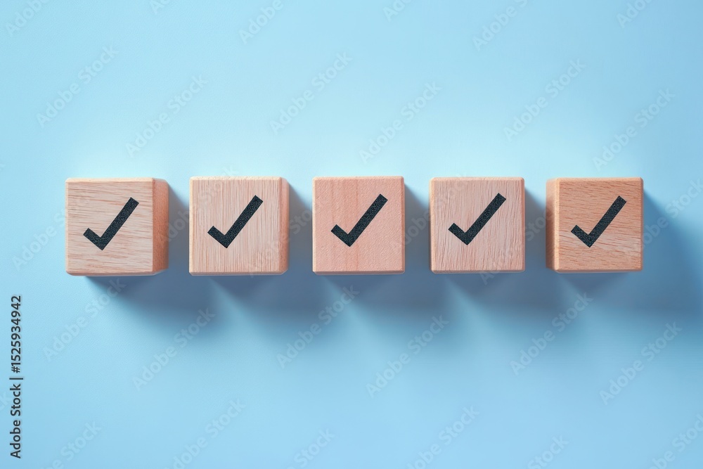 Obraz premium Five wooden cubes with black check marks lined up on a light blue surface casting shadows, symbolizing completion and approval