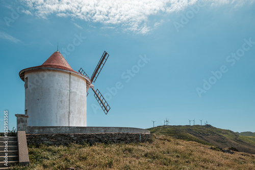The Moulin Mattei windmill, built at the end of the 18th century, stands on the Cap Corse peninsula on the Mediterranean island of Corsica with modern electricity generating windmills in the distance