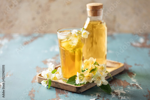 Jasmine green iced tea in a glass  on white wooden background
