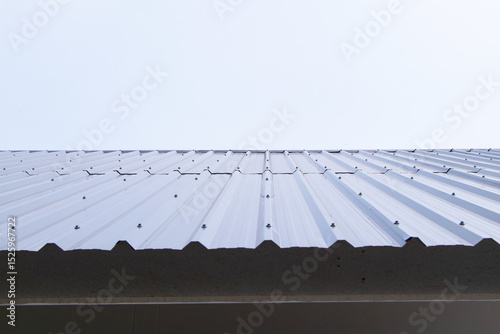 Aluminum or Zinc roof structure by white sky, cloud in background. Abstract texture background. Roof of house or building where people live.