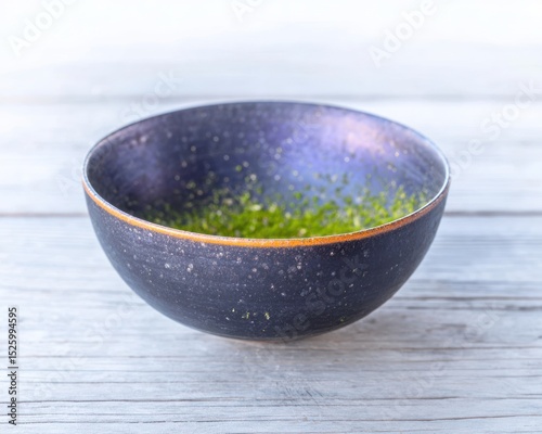 Empty dark bowl on white wood