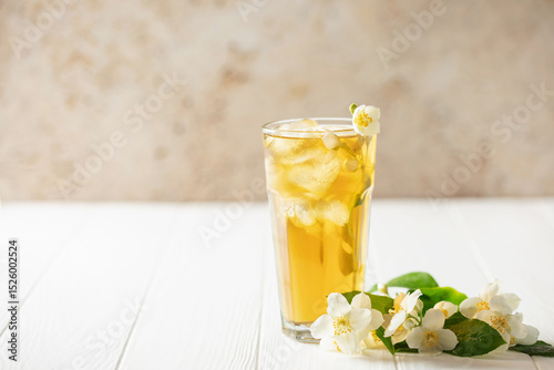Jasmine green iced tea in a glass  on white wooden background