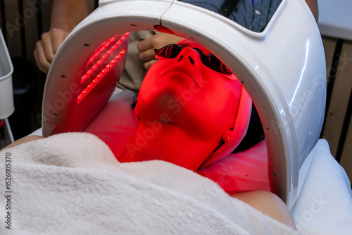 Facial LED Light Therapy Treatment in a Beauty Clinic with Red Light and Eye Protection