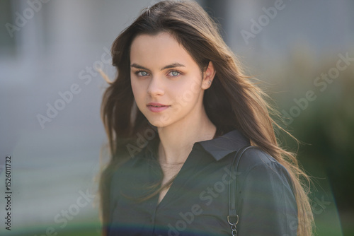 Portrait of a stylish teen girl outdoors. Teen model posing on street. Teenage girl with a serious face. Hipster teen girl. Urban lifestyle of a modern teen. Pretty youth posing outdoor.