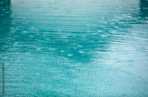 The water is blue and has raindrops on it