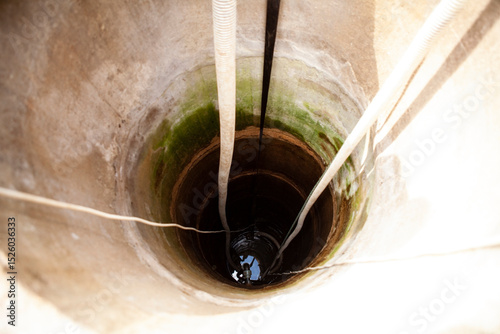 Cleaning a rural concrete well: The first stage involves pumping out all the water to the very bottom. This allows access to the well s base for thorough cleaning and sediment removal.
 photo