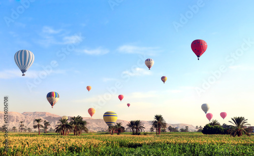 Famous tourist attraction balloon flight in Valley of Kings, Luxor, Egypt. Air balloons over the Theban Necropolis, Luxor, Egypt. Topic of vacation, travel, trip abroad on vacation, cruises and tours