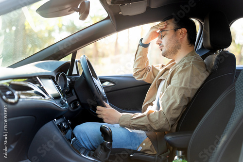 Stressed driver experiencing car trouble on road trip
