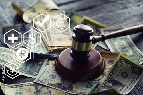 Judge gavel On Dollar Cash. Corruption, Bankruptcy Court, Crime, Bribing, Fraud, Auction Bidding concept.