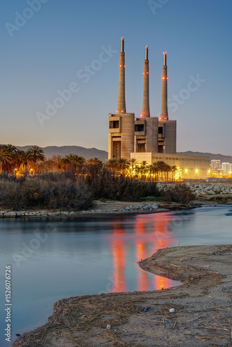 The shutdown thermal power station and the mouth of the Besos river at Sant Adria near Barcelona at twilight