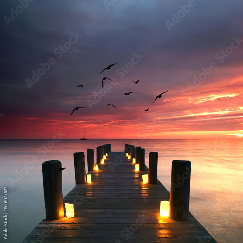 Candlelit Serenity: A Wooden Pier Amidst a Breathtaking Sunset