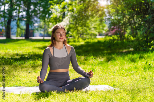Practicing yoga in a serene outdoor environment surrounded by nature