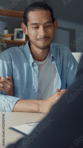 Vertical Screen : Happy asian young customer couple ready sign bank loan agreement for new house with broker agent, husband and wife consider finance investment insurance contract in front of broker.