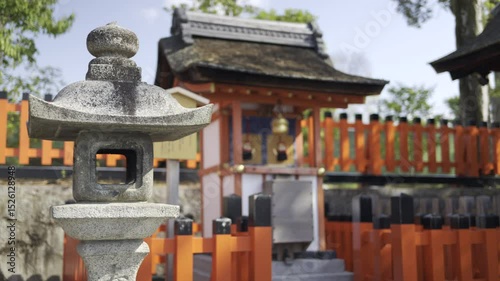 Fushimi-inari shrine nestled among trees, featuring orange fencing. Experience the serene atmosphere and traditional architecture unique to Japanese culture.
