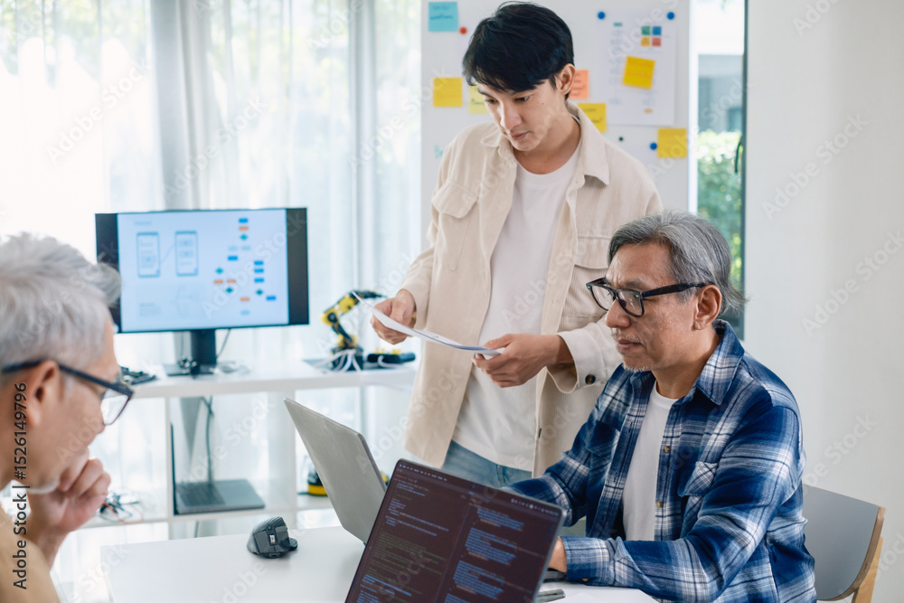 Fototapeta premium Asian Instructor Teaching Senior in Software Programming and Training Collaboration