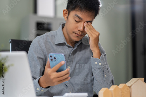 Asian male cover her face after stressed with credit card debt, house debt bankrupt stress concept.