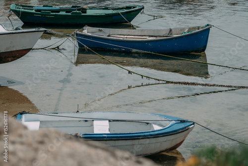 Old rustic wooden boats moored in the port photo