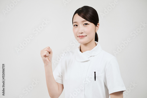ガッツポーズをする白衣の女性 photo