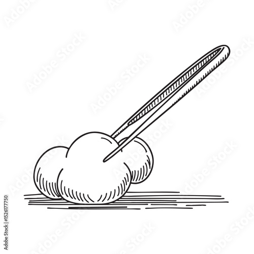 Tweezers near a piece of cotton on a table