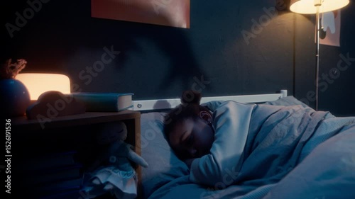 Little girl sleeping in bed in dark room at night with spooky hand silhouettes playing shadow game on wall under flickering light