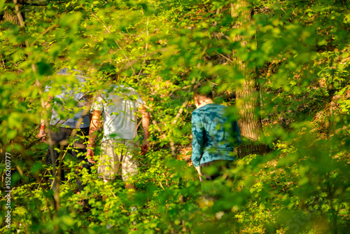 Father with his sons are walking on a hiking trail
