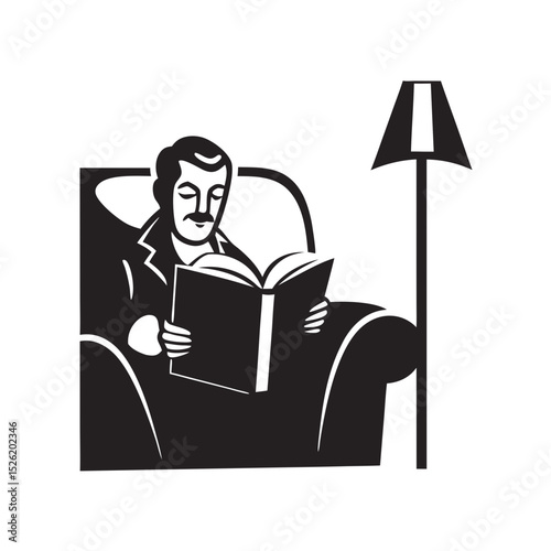 Man reading a book while sitting in an armchair beside a lamp  