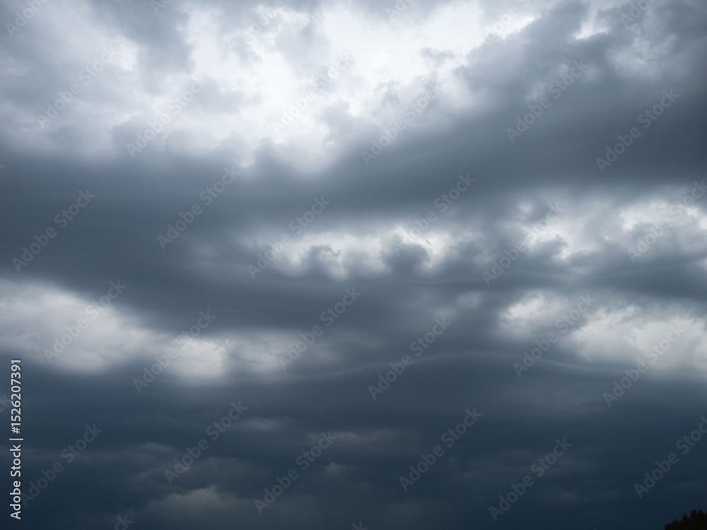 Obraz premium Dark, dramatic, oddly shaped clouds in the sky before a strong thunderstorm, bad weather, rain
